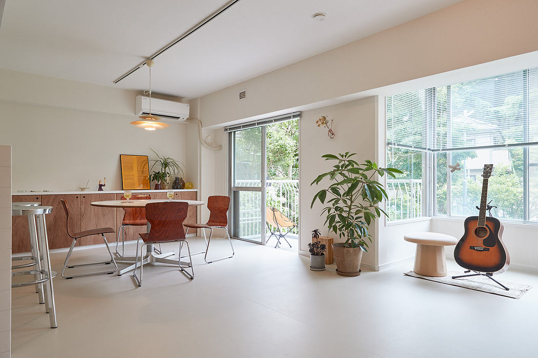 Bright, open-concept living space with large windows, wood accents, and musical instrument.