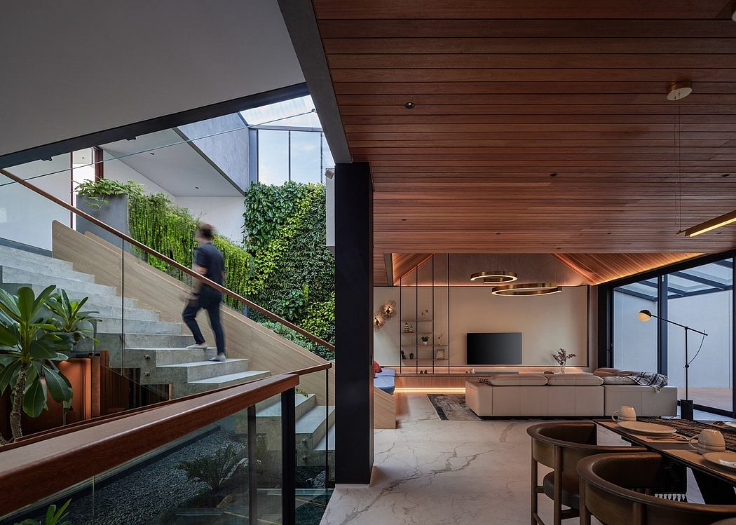 A modern interior with wooden paneling, glass walls, and a lush greenery backdrop.