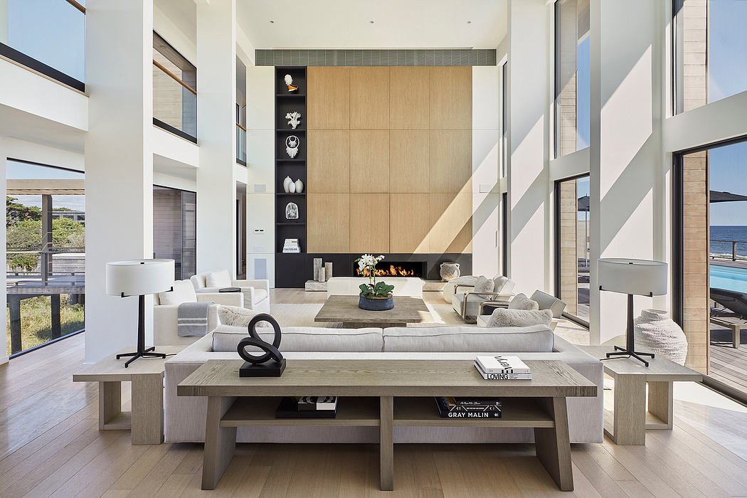 Spacious, modern living room with minimalist furniture, natural wood accents, and floor-to-ceiling windows overlooking a scenic view.