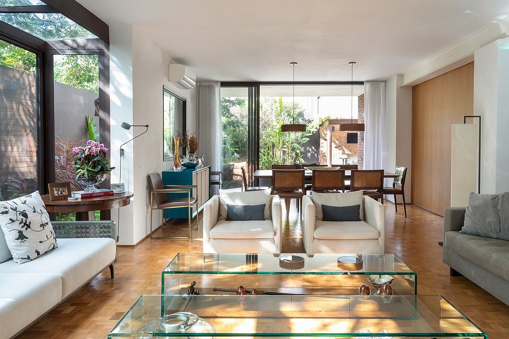 Bright, open-concept living space with large windows, sleek furniture, and decorative accents.