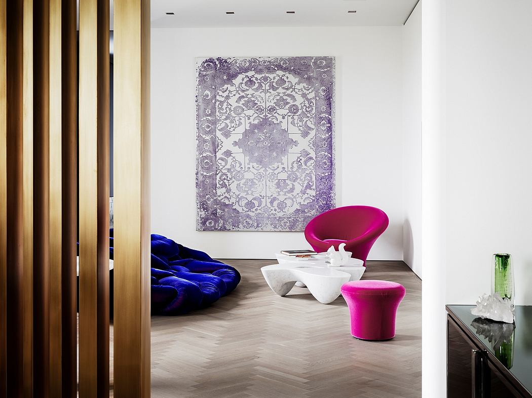 Vibrant modern room with geometric purple artwork, plush blue seating, and sculptural pink chairs.