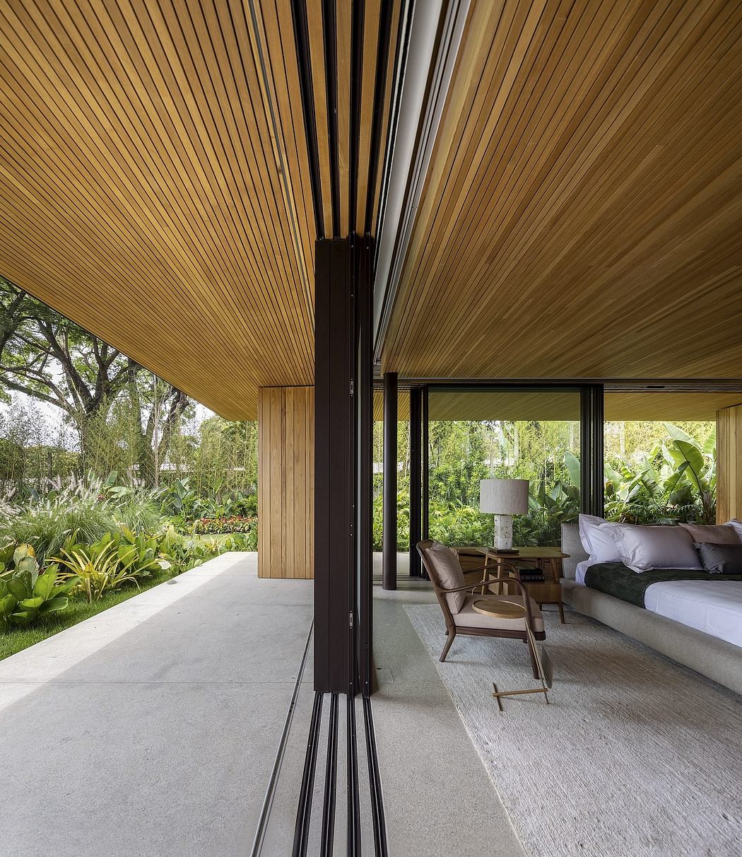 A modern wooden patio with sleek black frames, surrounded by lush greenery.