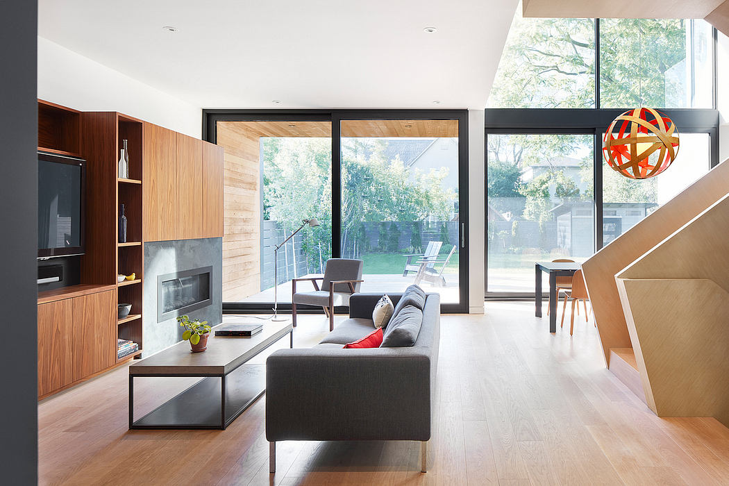 Bright, contemporary living space with wooden accents, large windows, and modern furnishings.