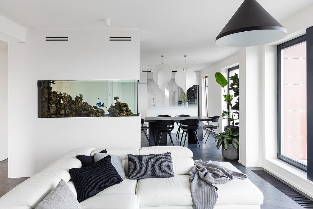 Modern, minimalist living room with large aquarium, contemporary lighting, and open-concept layout.