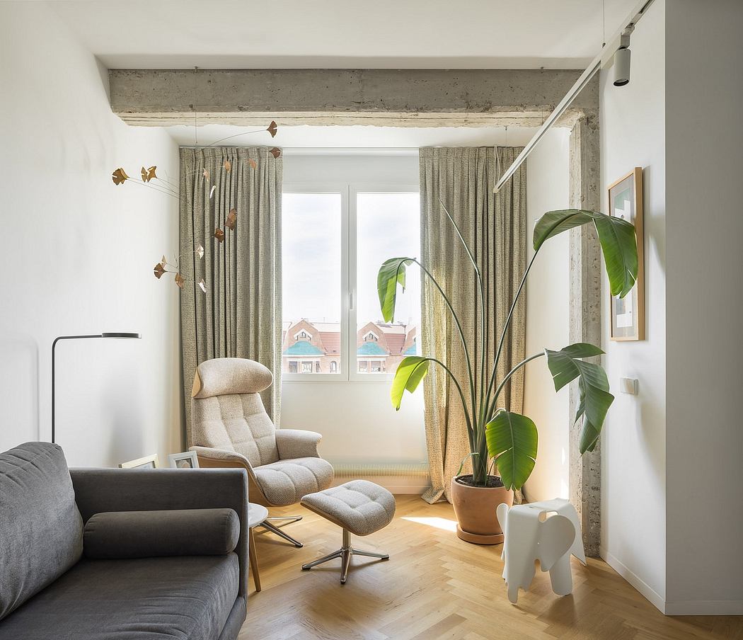 Modern interior with concrete ceiling, large windows, plush furniture, and lush tropical plants.