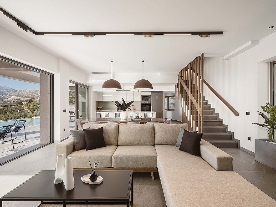 Spacious, modern living area with open-concept kitchen and sleek wooden staircase.