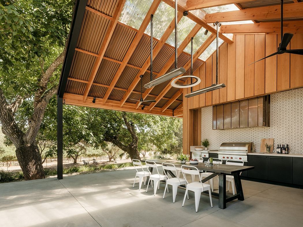 Inviting outdoor dining area with modern wooden architecture, concrete flooring, and sleek furnishings.