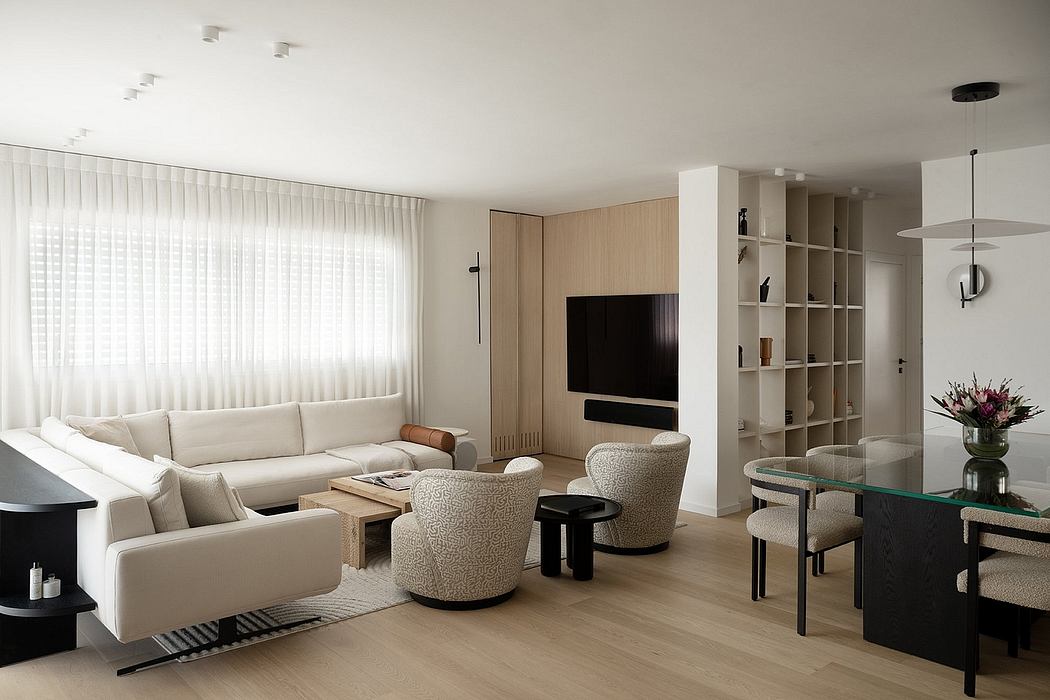 Spacious, well-lit living room with modern furnishings and neutral color palette.