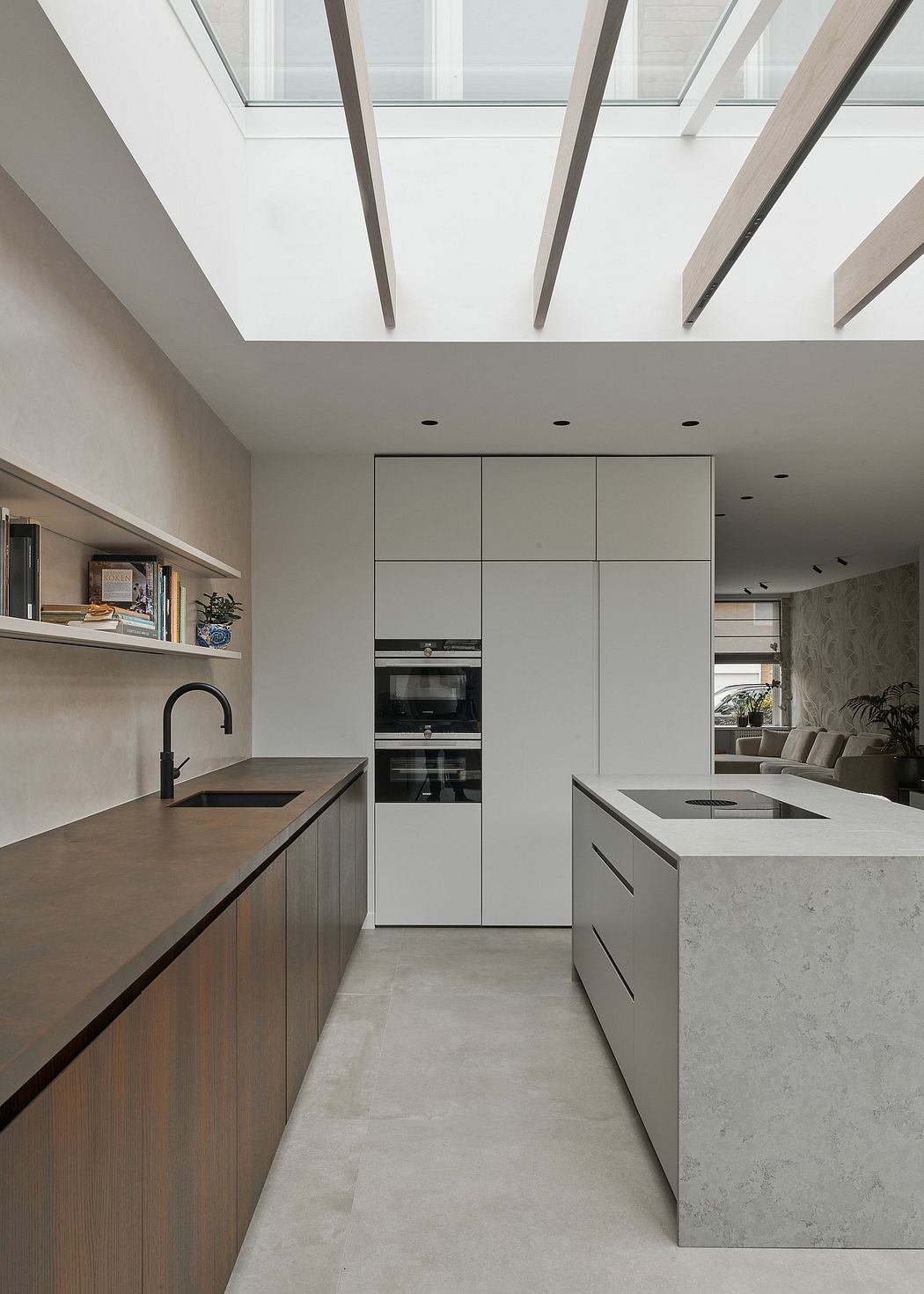 Sleek modern kitchen with minimalist cabinetry, integrated appliances, and a marble countertop island.