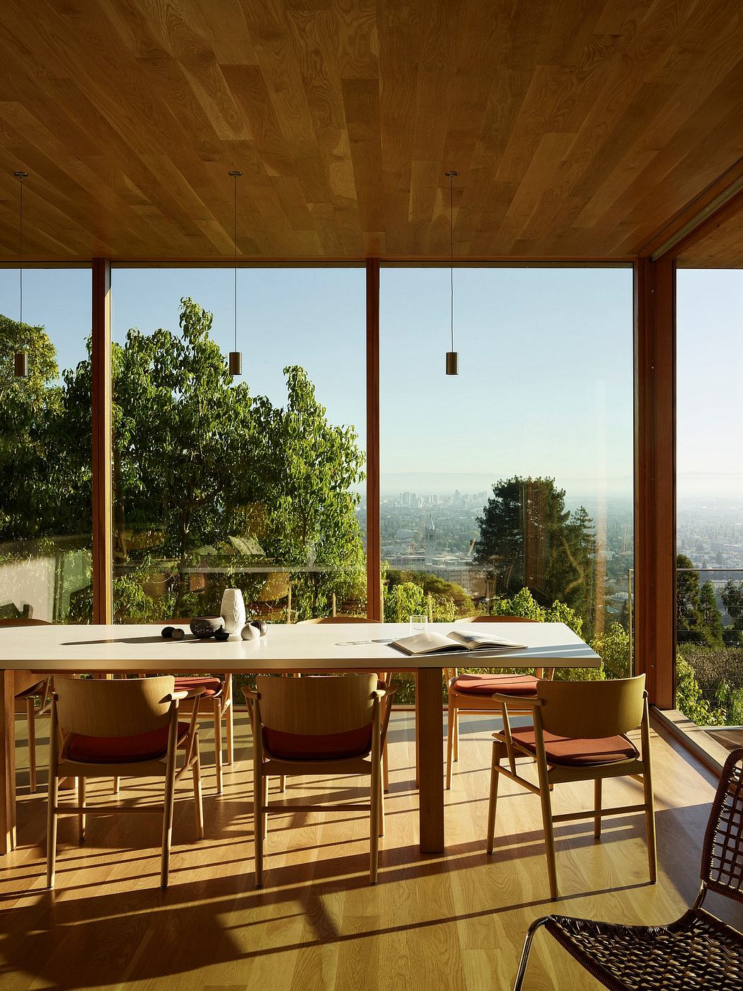 Spacious, modern living space with large windows overlooking a lush, natural landscape.