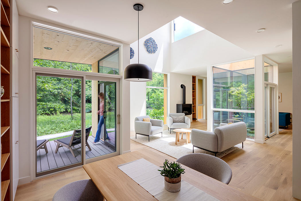 Spacious living area with high ceilings, large windows, and modern furnishings.