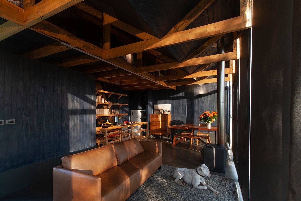 Cozy rustic cabin interior with wood-beamed ceiling, warm lighting, and leather furnishings.