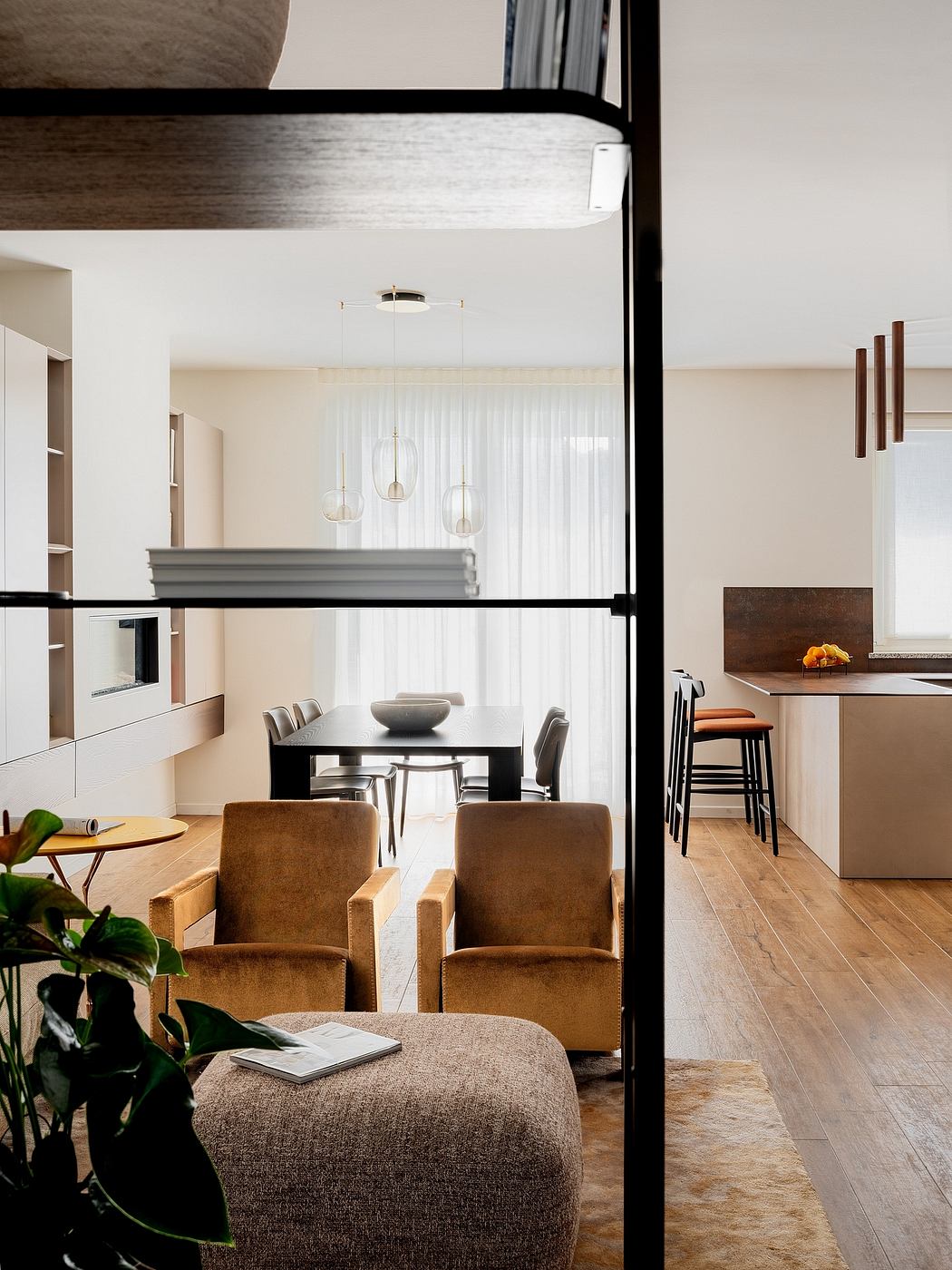 Sleek, modern kitchen with pendant lighting, wooden furniture, and cozy seating.