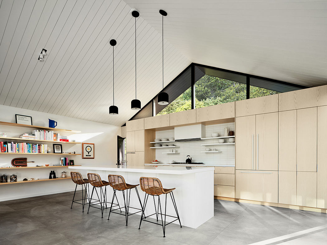 Airy, modern kitchen with sleek white cabinetry, exposed shelving, and minimalist lighting.