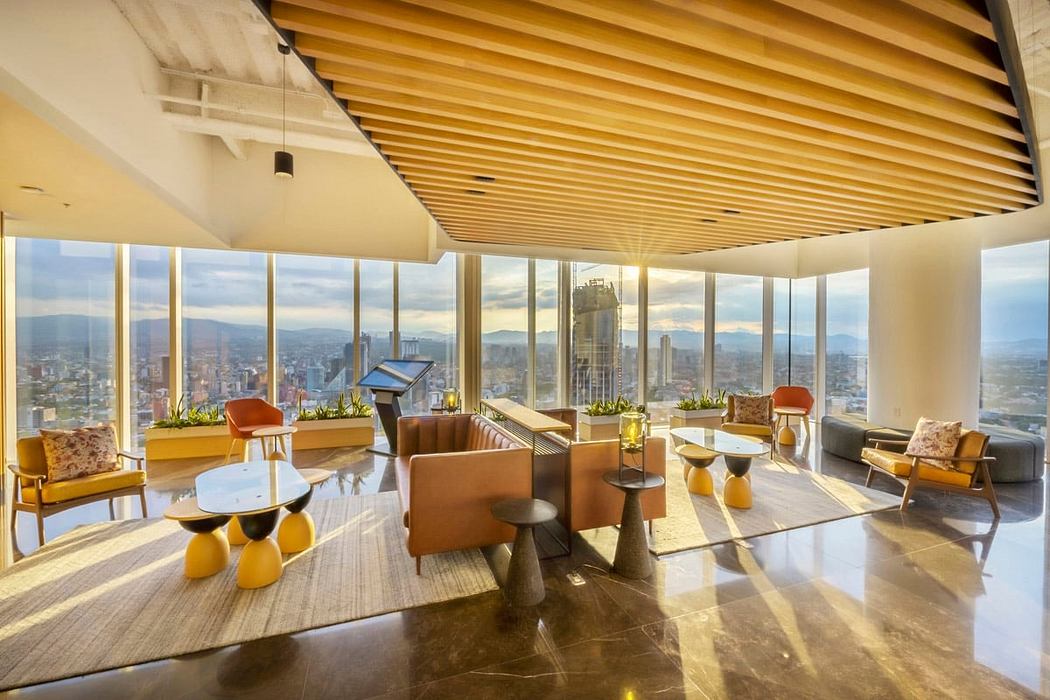 Elegant modern lounge with panoramic city views, wood-paneled ceiling, and warm-toned furnishings.