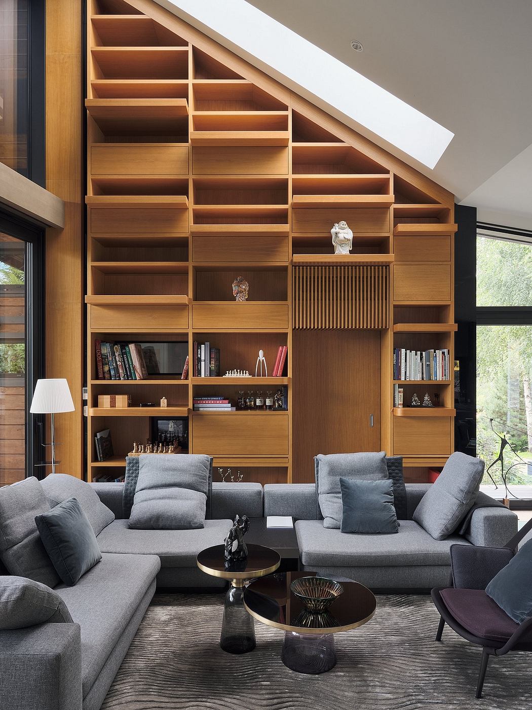 Elegant built-in wooden shelving unit with diverse storage compartments, set against a modern living room.