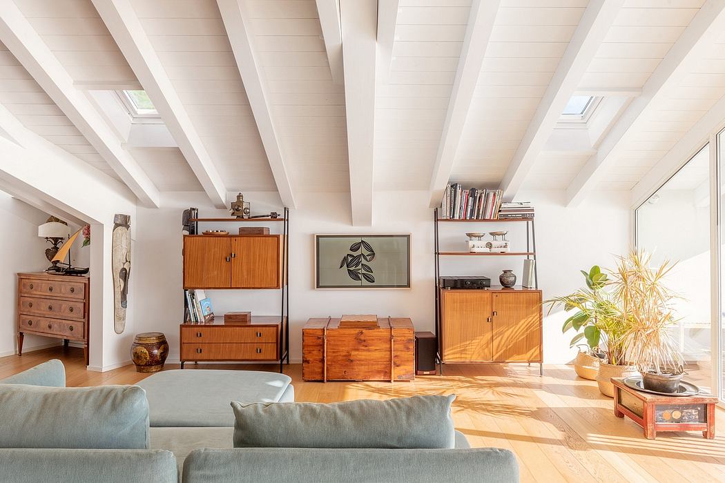 Spacious room with wooden furniture, framed artwork, and natural lighting through skylights.
