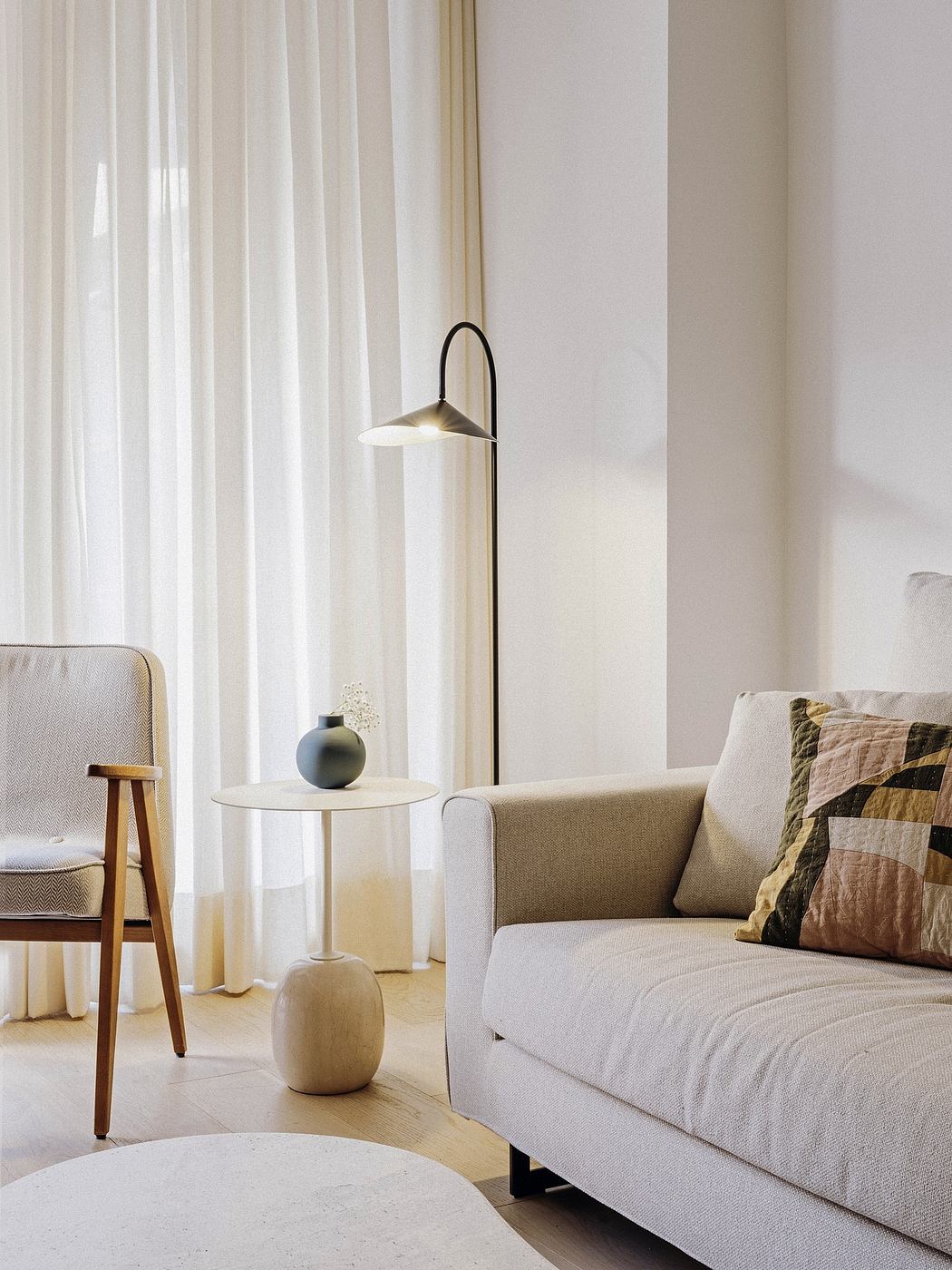 Warm, minimalist living room with a curved sofa, floor lamp, and decorative vases.