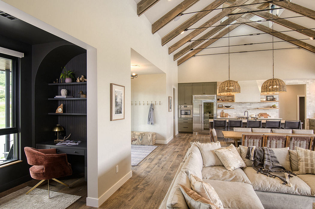 Spacious open-concept living room with vaulted ceilings, wooden beams, and modern furnishings.