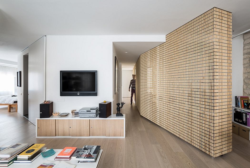 A modern living space with a sleek TV console, wood-paneled walls, and hardwood floors.
