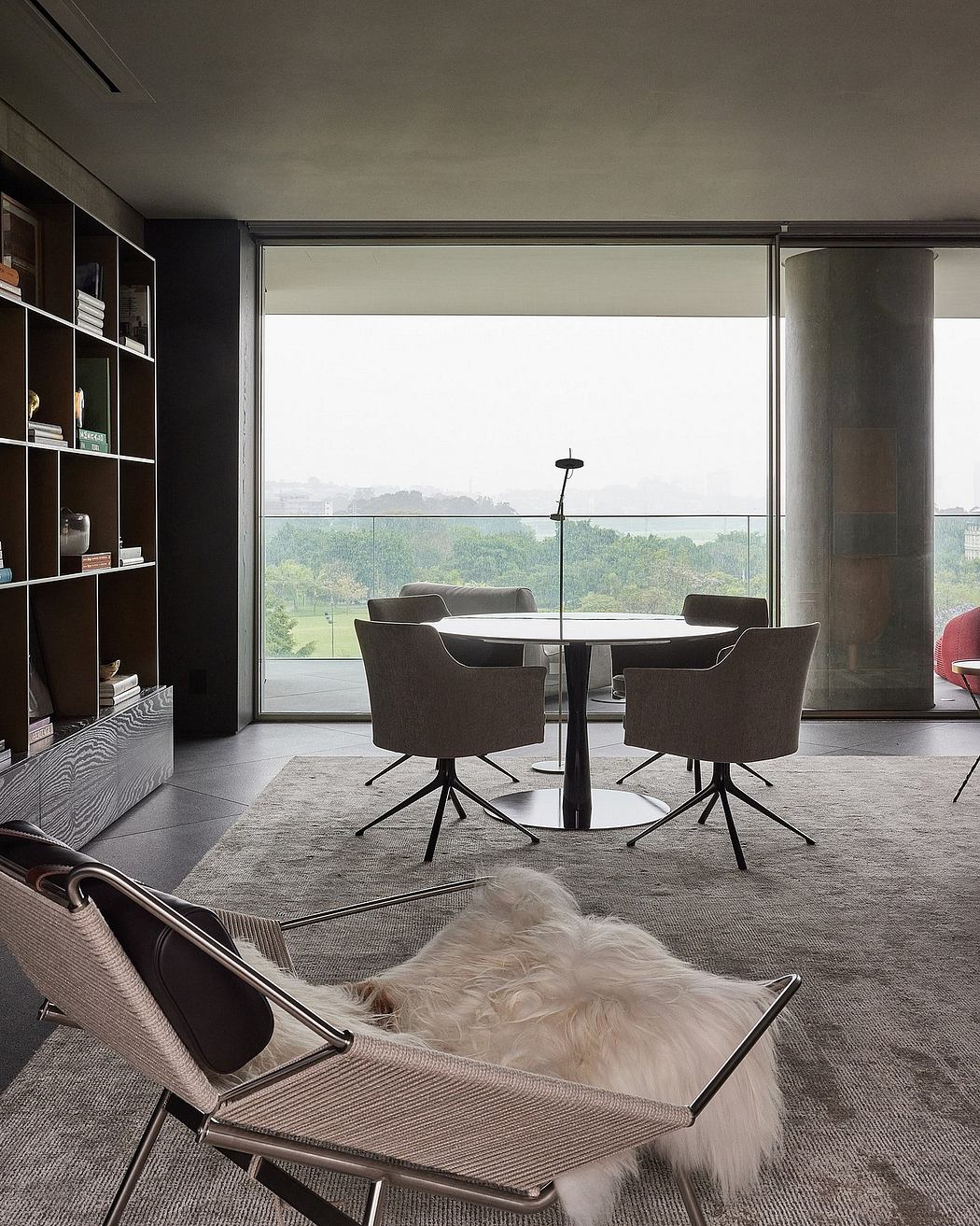 Sleek, contemporary dining room with panoramic window and minimalist furniture.