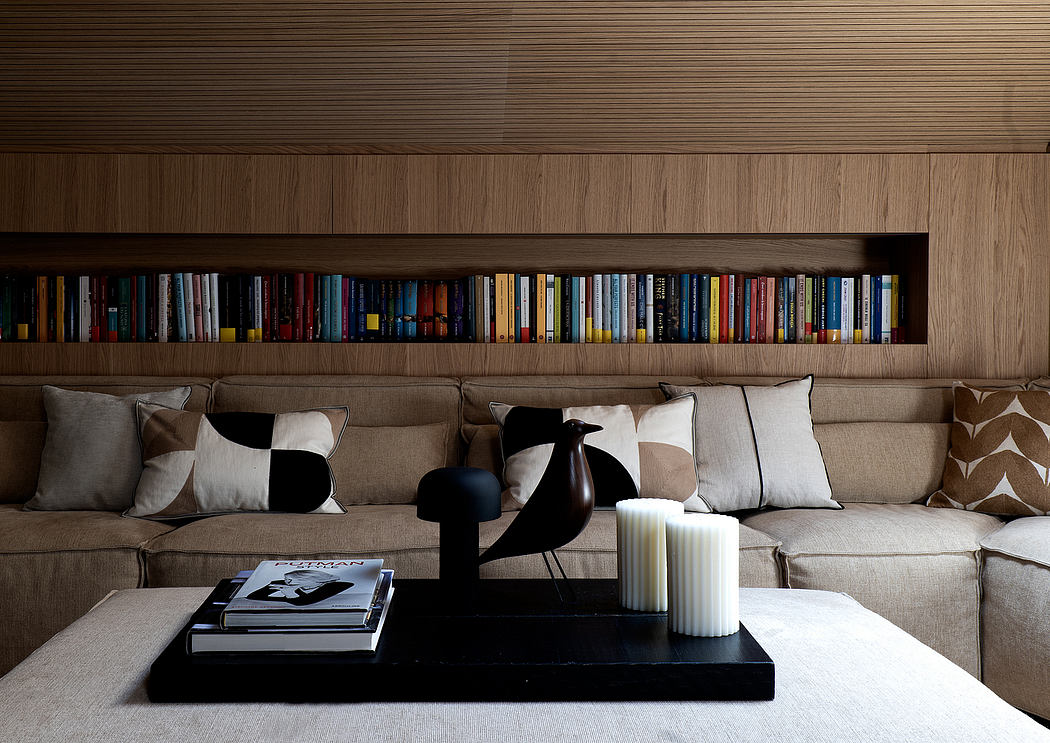Cozy living room with built-in bookshelves, plush sofa, and modern decor accents.