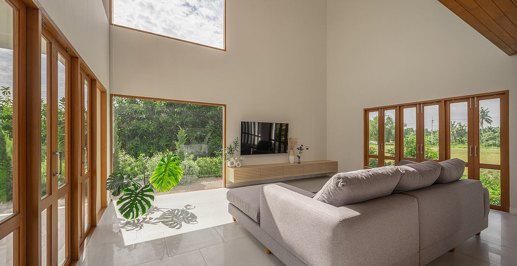 Expansive living area with floor-to-ceiling windows, neutral palette, and modern furnishings.