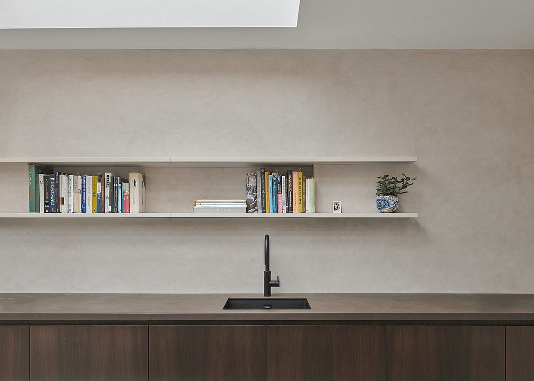 Minimalist kitchen design with floating shelves, dark wood cabinets, and a black sink faucet.