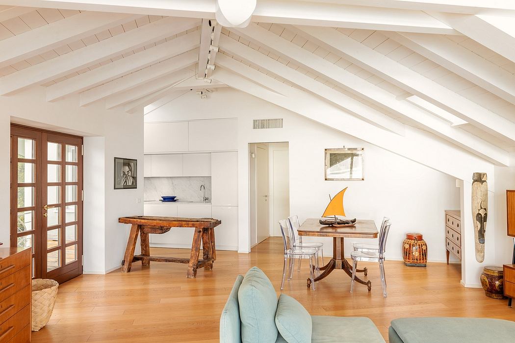 Bright, airy attic space with exposed beams, modern yet rustic furnishings.