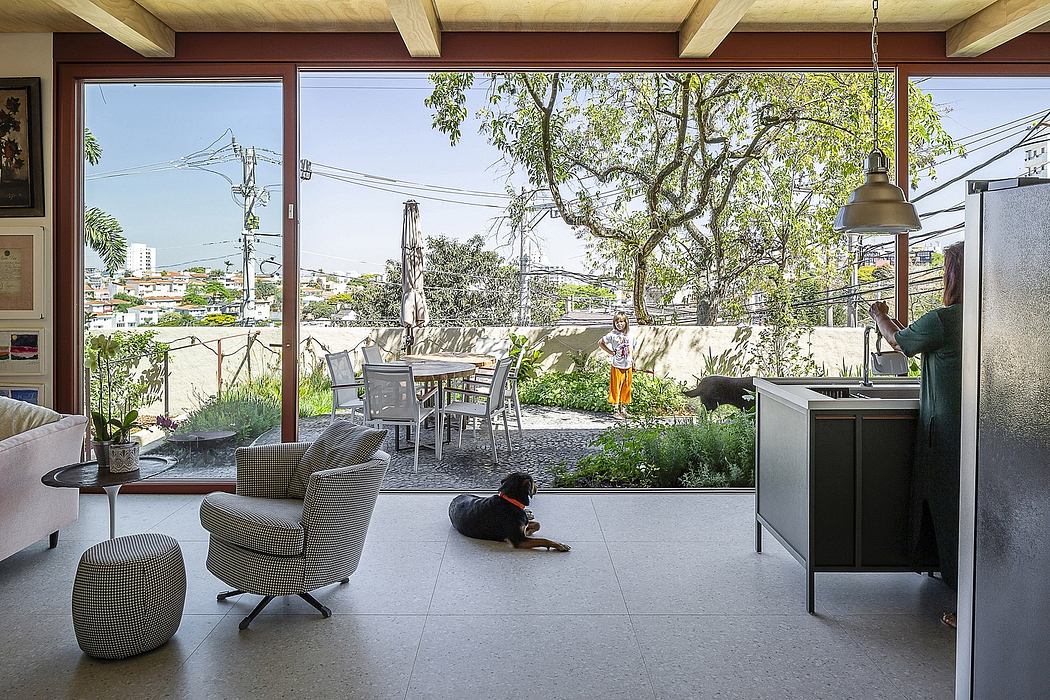Cozy modern interior with open outdoor patio, wooden beams, and dog lounging.