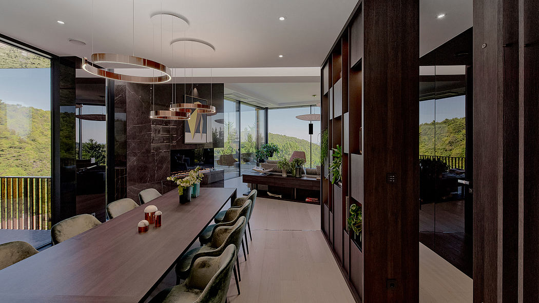 A modern, open-concept dining room with sleek wood paneling, pendant lighting, and expansive views.