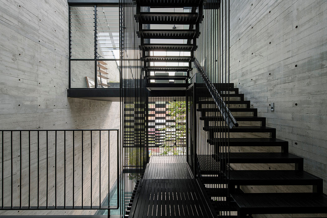 Dramatic concrete and metal staircase with striking geometric design elements.