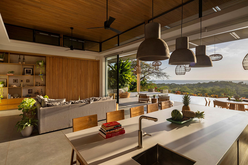 Warm, modern interior with natural wood accents, pendant lighting, and expansive view.