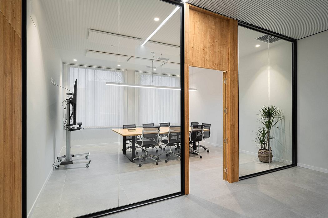Modern, sleek office space with wooden accents, glass walls, and minimalist furniture.