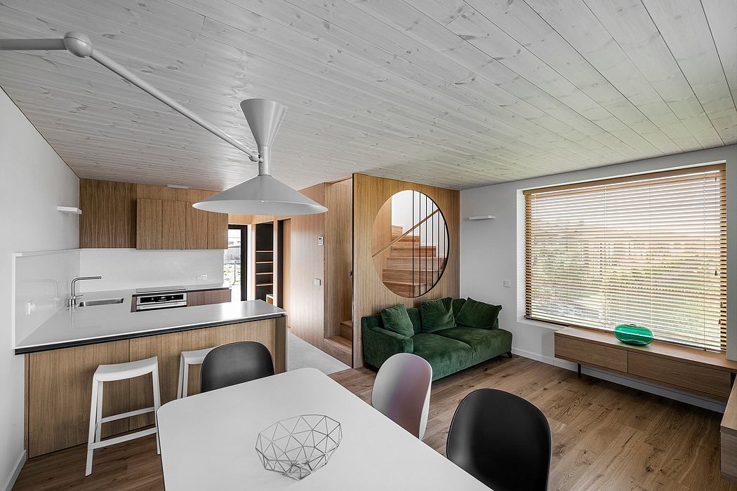 Cozy modern interior with wood paneling, curved archway, and open-concept layout.