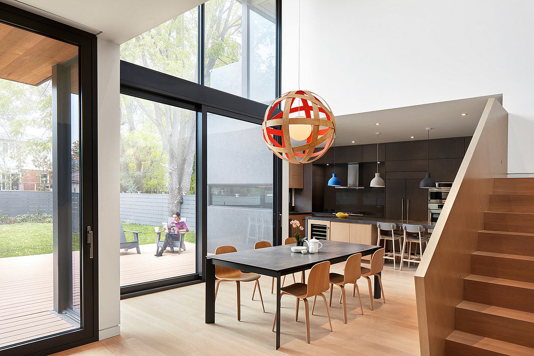 Modern open-plan kitchen and dining area with a striking red and white globe pendant light.