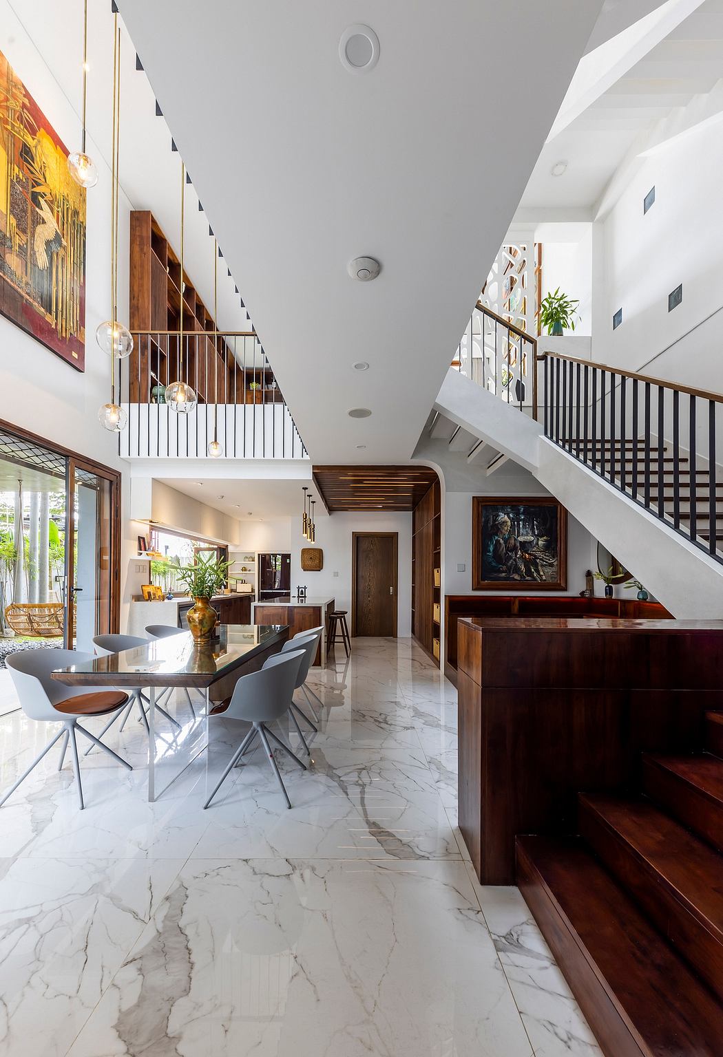 Spacious open-concept living area with marble flooring, wooden accents, and modern furnishings.