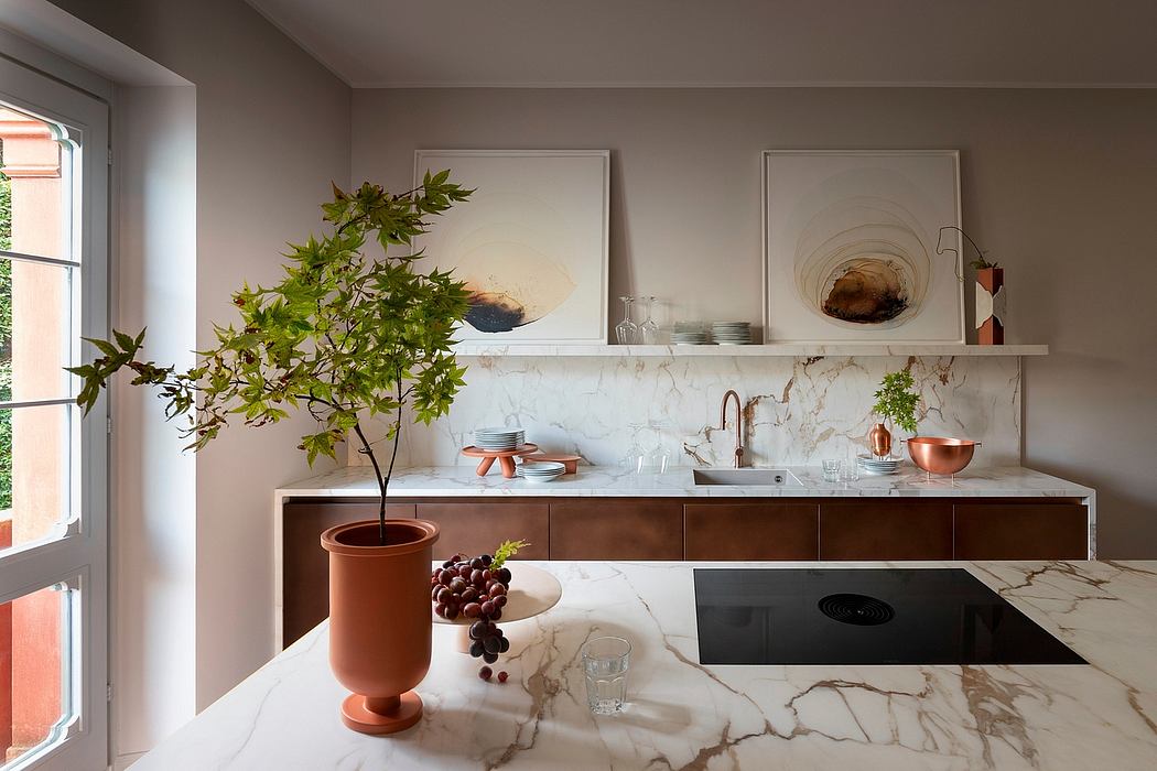 Modern kitchen with marble countertops, natural wood cabinetry, and potted plant decor.