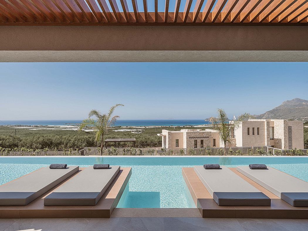 Luxurious pool and lounge area with Mediterranean-style architecture and ocean view.