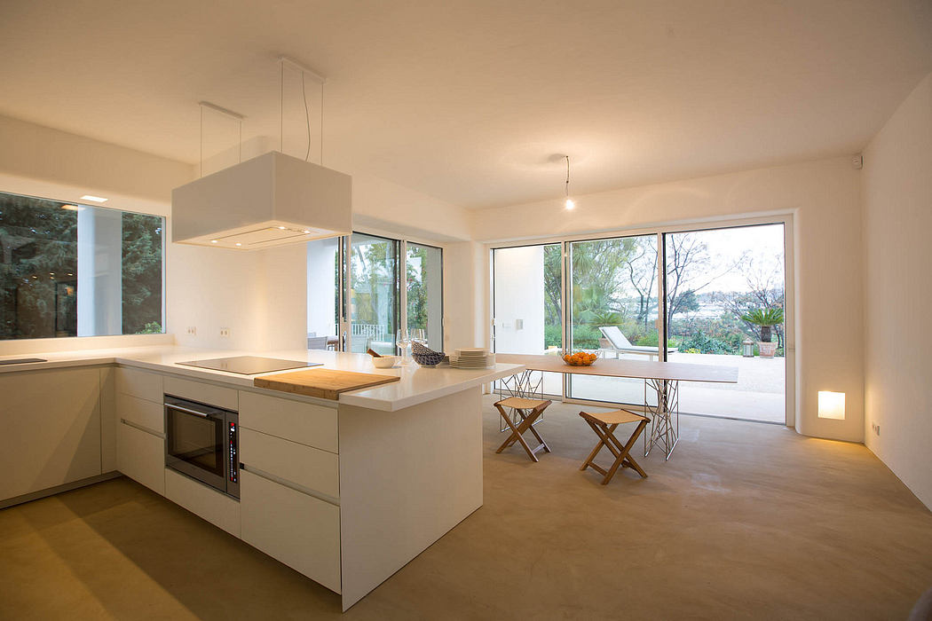 Bright, modern kitchen with large windows, wooden accents, and minimalist design.