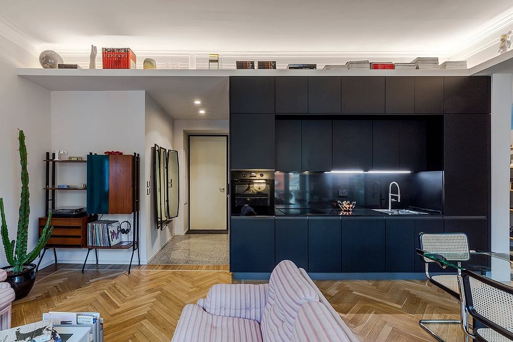 Sleek, modern kitchen with black cabinetry, parquet floors, and eclectic decor elements.