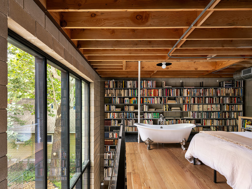 A cozy bedroom in a rustic lodge-like setting, with a clawfoot tub and floor-to-ceiling bookshelves.
