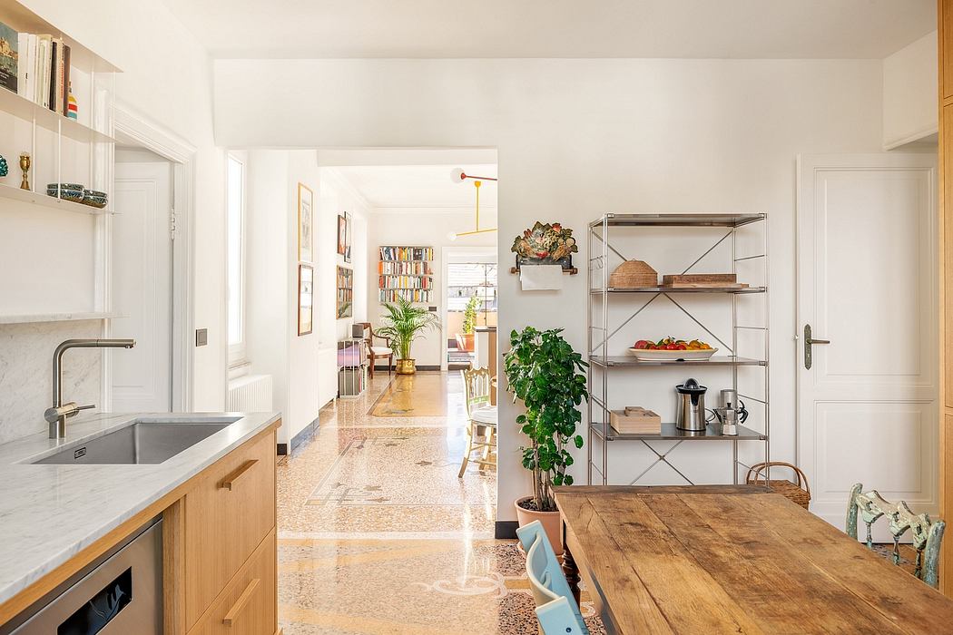 Open, light-filled kitchen with natural wood furnishings, ample shelving, and potted plants.