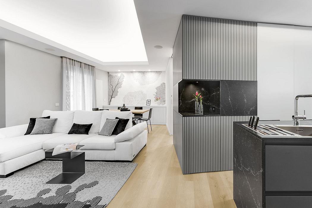 Minimalist living room with stylish black and white furnishings, elegant lighting, and modern architectural features.