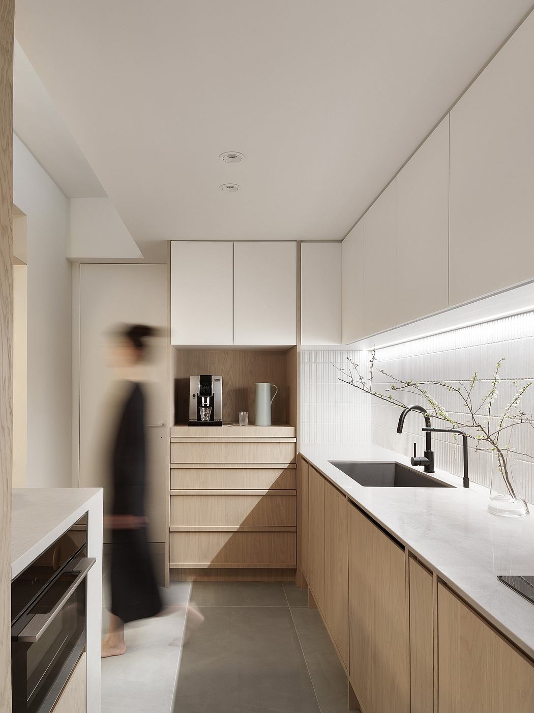 Minimalist kitchen with clean lines, neutral tones, and modern built-in cabinetry.