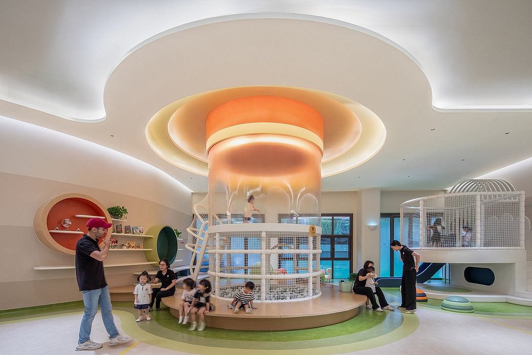 A circular, multi-level children's play area with colorful lighting and modern, playful design.
