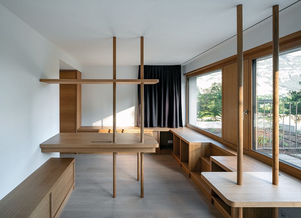 A contemporary, minimalist living space with wooden architectural elements and built-in furniture.