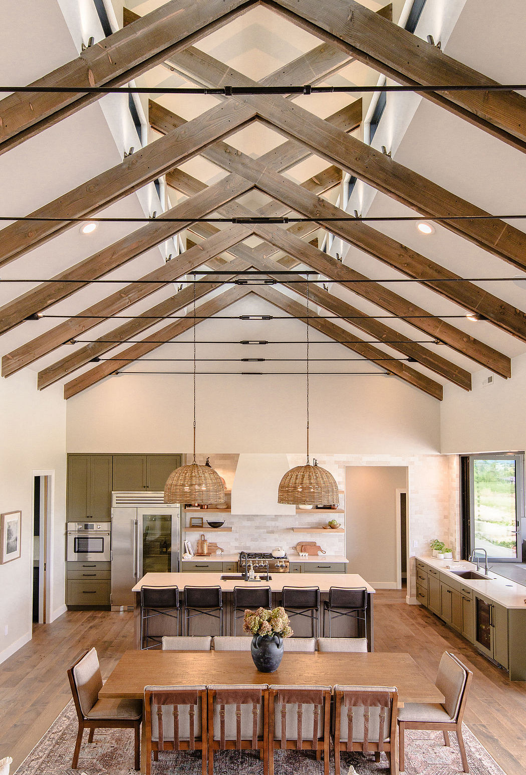 Rustic wood ceiling beams, recessed lighting, and a spacious kitchen-dining area.
