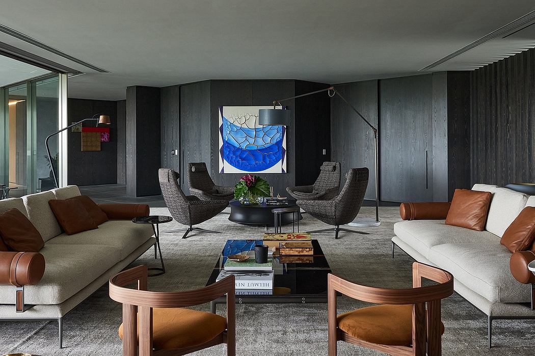 Sleek, modern living room with dark wood paneling, statement artwork, and diverse seating.