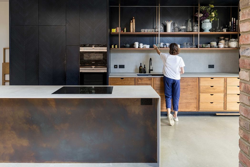 A modern kitchen design with dark cabinetry, wooden drawers, and a concrete countertop.